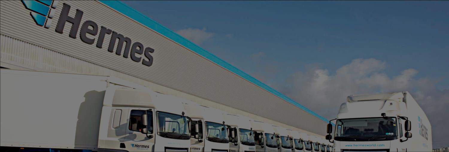 Fleet of Hermes delivery vehicles parked outside a distribution centre